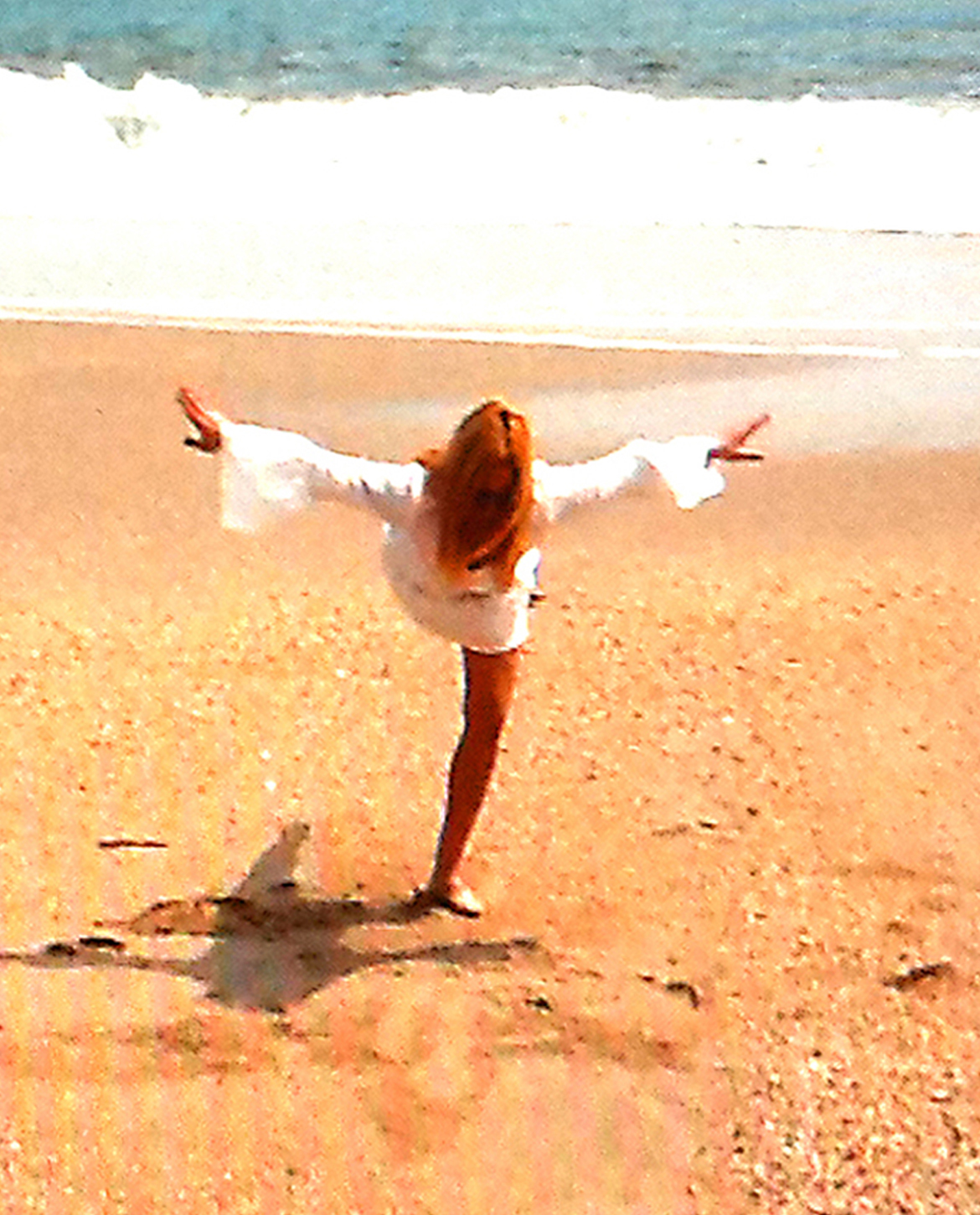 Jane Rubin, Dancer, Choreographer, Painter and Composer performing modern dance arabesque on beach in 2010. Copyright Jane Rubin 2010.